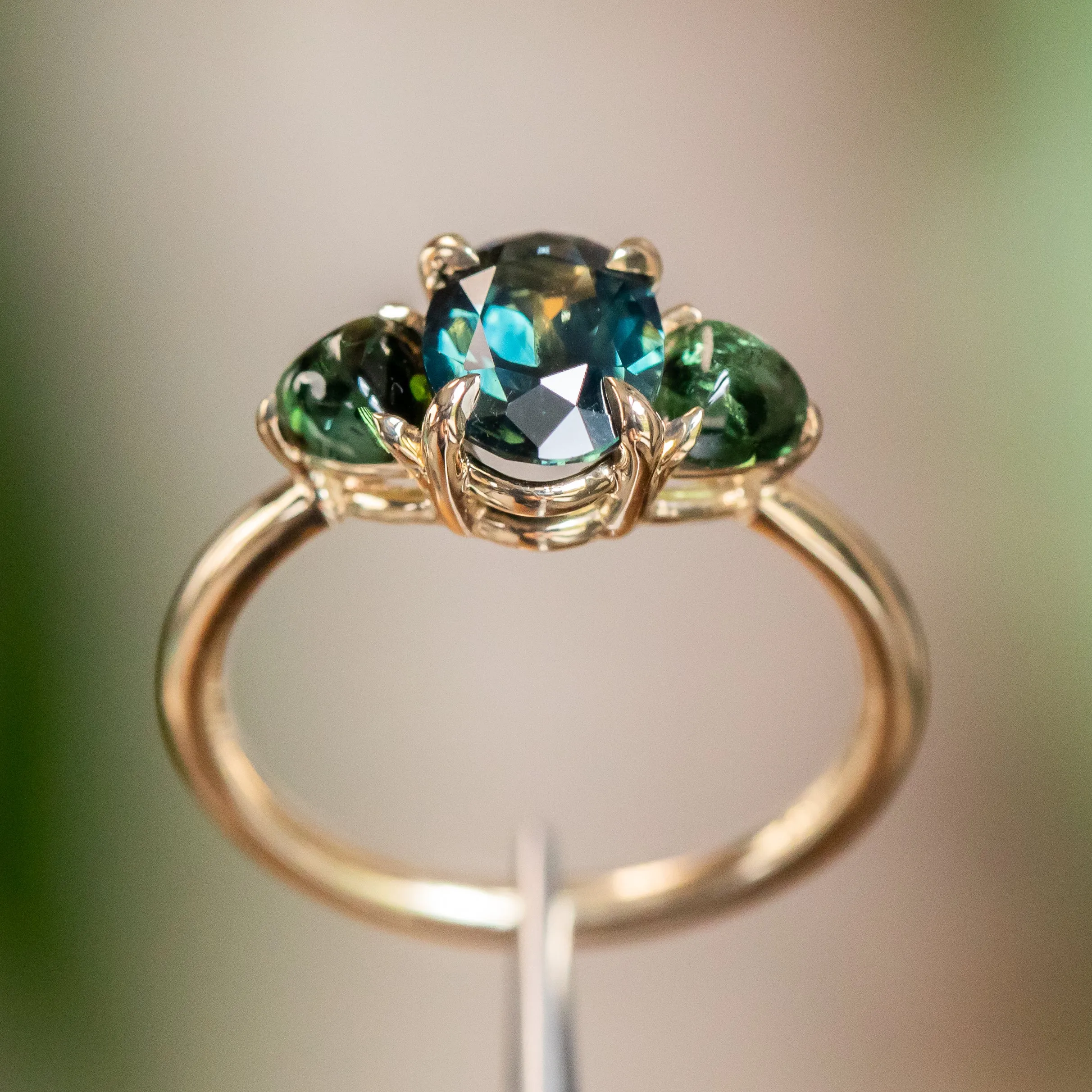 1.63ct Oval African Teal Blue Sapphire and Tourmaline Cabochon Trillion Three Stone Ring in 14K Yellow Gold