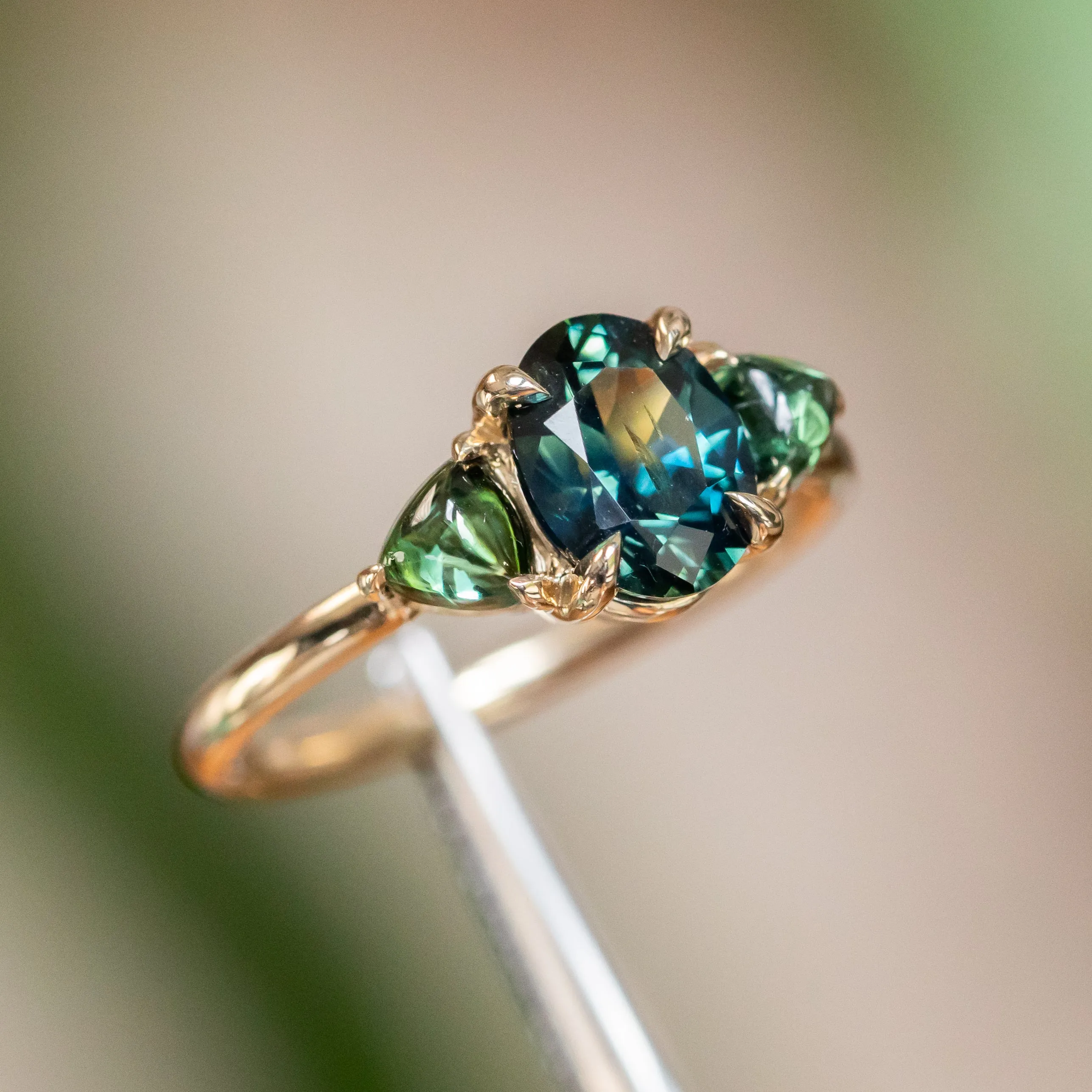 1.63ct Oval African Teal Blue Sapphire and Tourmaline Cabochon Trillion Three Stone Ring in 14K Yellow Gold